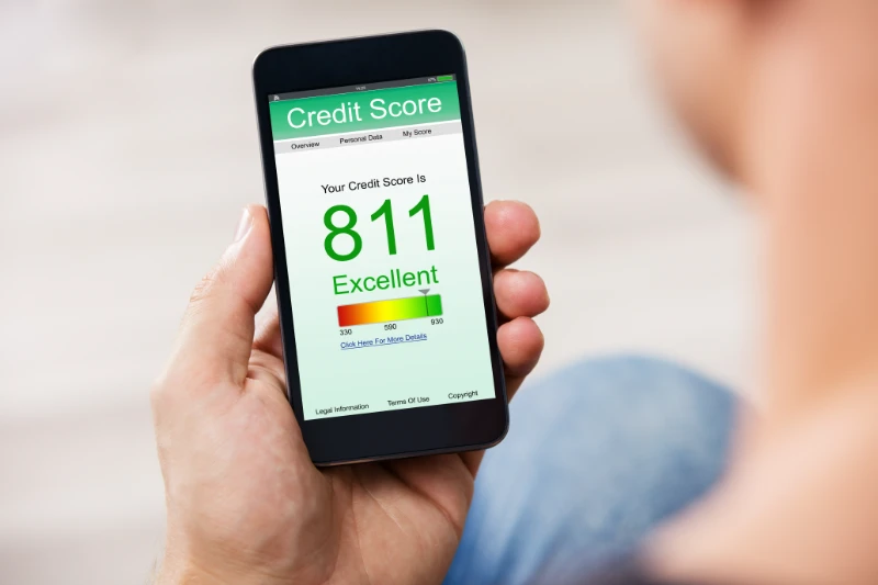 Man Holding Smart Phone Showing Credit Score Application On A Screen